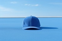 Cap blue headwear outdoors. 