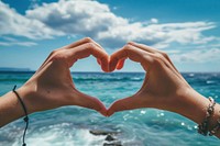 Two hands that are making a heart shape adult sea tranquility. AI generated Image by rawpixel.