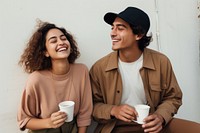 Latinx couple laughing drinking coffee. AI generated Image by rawpixel.