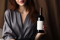 Wine bottle holding drink. AI generated Image by rawpixel.