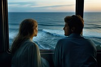 A woman and man on a train looking at the ocean from a window portrait nature adult. AI generated Image by rawpixel.