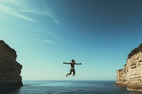 People jumping out of a cliff in front of transparent sea outdoors nature diving. AI generated Image by rawpixel.