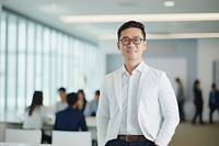 An Eastern Asian businessman standing and talking glasses adult shirt. AI generated Image by rawpixel.