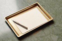 Card paper and pen on a gold tray