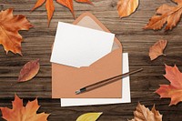 Autumn greeting card in brown envelope, flat lay