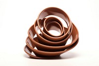 Spiral spring chocolate white background terracotta. AI generated Image by rawpixel.