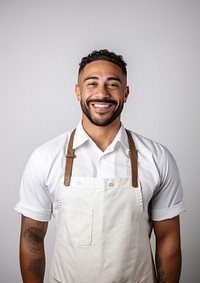 A multiracial man wearing white linen shirt with a brown apron smiling adult smile. AI generated Image by rawpixel.