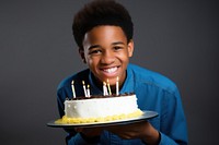 African American a boy teenage smile party cake. 