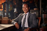Old cambodian businessman sitting adult entrepreneur. AI generated Image by rawpixel.