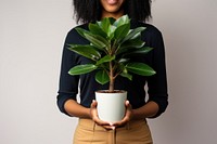A black woman holding houseplant leaf midsection flowerpot. AI generated Image by rawpixel.