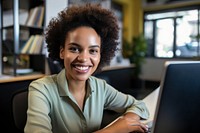 South African businesswoman using a computer smiling laptop office. AI generated Image by rawpixel.