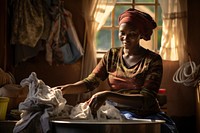 Kenyan woman doing her laundry headscarf portrait poverty. 