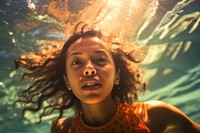 A Latina Brazilian teenage girl enjoying her time swimming underwater portrait outdoors nature. AI generated Image by rawpixel.
