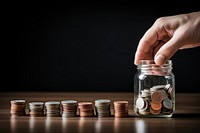Hand holds a coin jar money investment. AI generated Image by rawpixel.