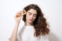 The woman is brushing her hair adult white background contemplation. AI generated Image by rawpixel.