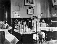 Hahnemann Hospital and Homœopathic Dispensaries, Liverpool: a children's ward, decorated with flags possibly for the coronation of King George V. Photograph.