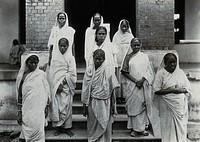 The Albert Victor asylum for lepers, Gohea, Calcutta, India: female patients in white saris on the steps of the female block. Photograph, 1900/1920.