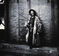 Peking, Pechili Province, China: a nightwatchman. Photograph, 1981, from a negative by John Thomson, 1869.