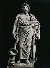 Aesculapius: the Greek god of healing. Photograph, 1900/1920 , of a sculpture.