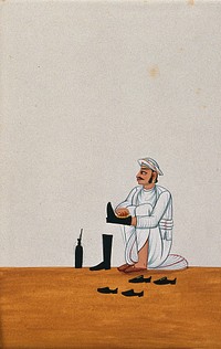 A servant polishes boots and other shoes. Watercolour by an Indian artist.