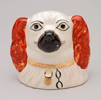 Staffordshire-style dog's head; black muzzle; red ears; gold collar with black chain; coin slot at top of head; shiny glaze finish. Original from the Minneapolis Institute of Art.