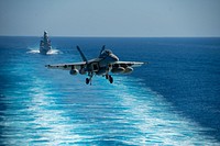 MEDITERRANEAN SEA (July 3, 2021) An F/A-18E Super Hornet, attached to the "Gunslingers" of Strike Fighter Squadron (VFA) 105, prepares to land on the flight deck of the Nimitz-class aircraft carrier USS Dwight D. Eisenhower (CVN 69), as the Italian Horizon-class destroyer ITS Andrea Doria (D 553) sails in formation with Ike in the Mediterranean Sea.