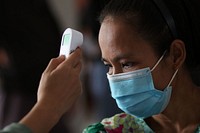 Medical staff measuring patient's temperature. Original public domain image from Flickr