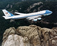 Air Force One, the typical air transport of the President of the United States of America, flying over Mount Rushmore.