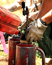 Fuels Management, Drip TorchesIn this photo firefighters are preparing drip torches to be used in a fuels management project. Fuels treatments are conducted to reduce fuel loads. Fuel loading can be caused by dead and down trees as well as an overgrown understory. Through fuels treatments firefighters address the problem of excessive ground fuels while using terrain and optimal weather conditions to their advantage. The fuels treatment project captured here took place on the West Desert District in northwestern Utah. This is a 7.7-million-acre district managed by the Bureau of Land Management.  Photo Credit: Austin CatlinFire Operations SpecialistIdaho Falls District BLM 