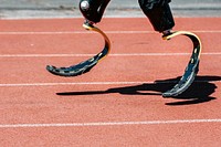 Man paralympic athlete running with prosthetic legs