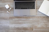 Free AirPods and laptop on wooden desk flat lay image, public domain CC0 photo.