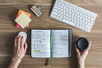 Free flat lay of notebook at work desk during breakfast photo, public domain CC0 image.