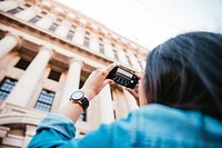 Free tourist taking photo of building image, public domain travel CC0 photo.