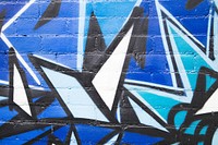 Free close up of blue, black and white spray painted designs on a brick wall image, public domain CC0 photo.