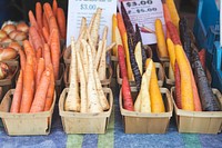 Free colored carrots and parsnips at a farmer's market photo, public domain food CC0 image.
