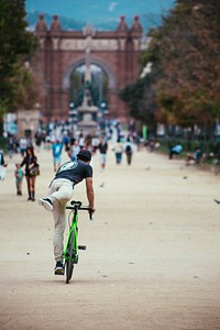 Free man cycling down narrow street image, public domain activity CC0 photo.