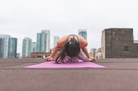 Free woman doing yoga pose on city rooftop building photo, public domain sport CC0 image.