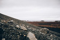 Volcanic rocks sliding down the black sand. The true nature of Iceland, free public domain CC0 image.