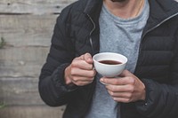 Free hand holding a cup of coffee photo, public domain drink CC0 image.