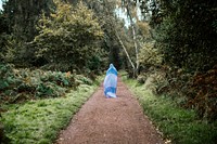 Free woman in blue standing on forest path photo, public domain nature CC0 image.