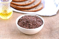 A breakfast table set with a focus on a bowl of flax seeds. This is probably a bird's house.