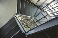 Looking up from the center of a triangular staircase at the bottom.