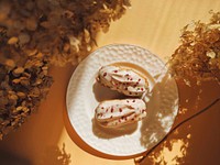 Free delightful eclairs with white glaze and raspberry crumb image, public domain food CC0 photo.