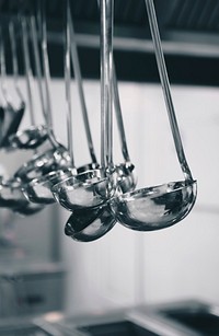 Shiny ladles in a restaurant kitchen, free public domain CC0 image.