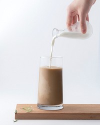 Free pouring milk into coffee glass with white background photo, public domain beverage CC0 image.