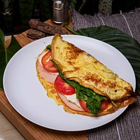 Free omelet with ham, cheese, spinach and tomatoes image, public domain food CC0 photo.