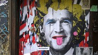 George W. Bush in a Marilyn Monroe style wig, graffiti in East London's Shoreditch area, 17th March 2014.