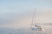 A sailing boat in foggy sea. Original public domain image from Flickr