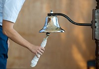 A person ringing ship's bell.Original public domain image from Flickr