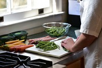 Chef preparing vegetables dishes in the kitchen. Original public domain image from Flickr